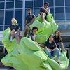 Members of the 2021 iGEM team pose atop a bright green sculpture outside IGB.