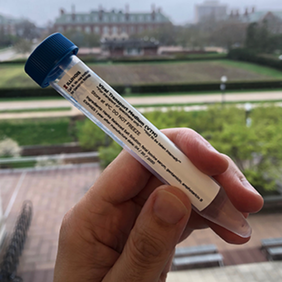A vial of Viral Transport Medium produced at the Carl R. Woese Institute for Genomic Biology. The fluid is used to preserve patient test samples for COVID-19. (Image courtesy of the Carl R. Woese Institute for Genomic Biology.)