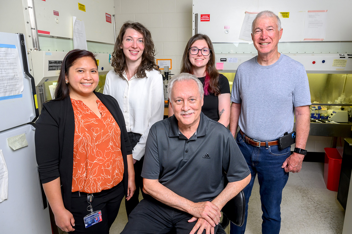 Researchers from the University of Illinois Urbana-Champaign who worked on a CAR-T immune therapy gather in a lab for a photo. Pictured, from front left: postdoctoral researcher Diana Rose Ranoa, graduate student Claire Schane, professor emeritus of biochemistry David Kranz (front center), researcher Amber Lewis and professor emeritus of pathology Edward Roy.