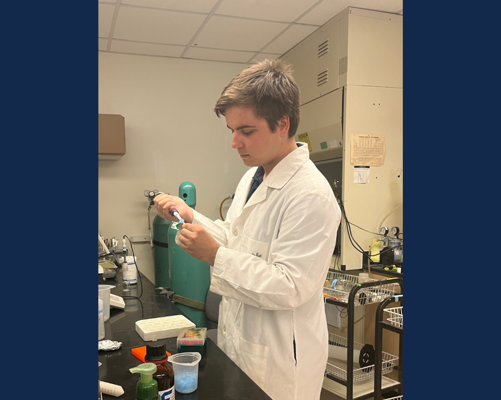 A man in a white lab coat using a pipette