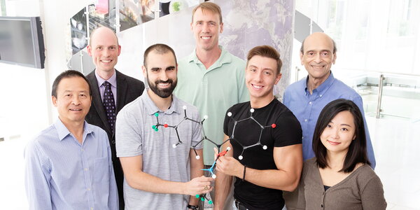 Illinois researchers pose for photo holding model of molecule. Researchers include, from front left, research scientist Chengjian Mao and graduate students Matthew Boudreau, Darjan Duraki and Ji Eun Kim. In the back row, from left, are molecular and integrative physiology professor Erik Nelson, chemistry professor Paul Hergenrother and biochemistry professor David Shapiro. Photo by L. Brian Stauffer