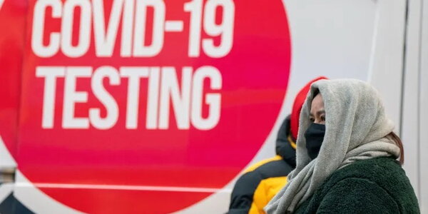 People brace against the cold while waiting for the coronavirus disease (COVID-19) test as a winter cold front hits, in New York City, U.S., January 15, 2022. David “Dee” Delgado | Reuters
