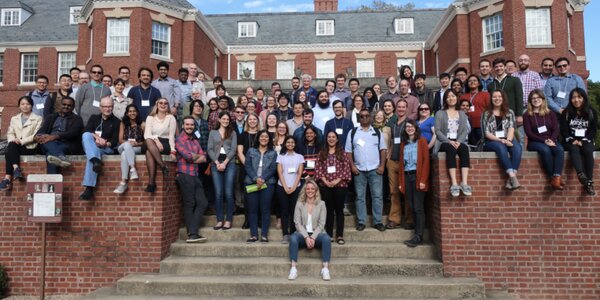 Several dozen members of the microbiology department pose for a large group photo on the steps at Allerton.