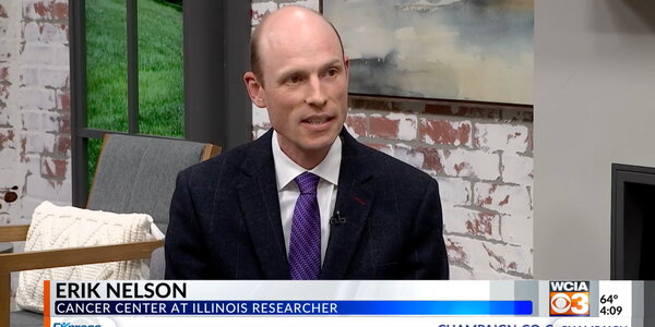 A man in a black suit giving an interview.