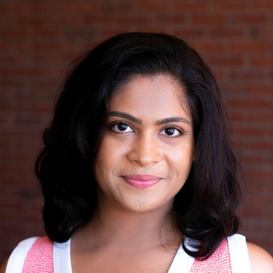 Headshot of Janhavi Kolhe with a brick wall background.