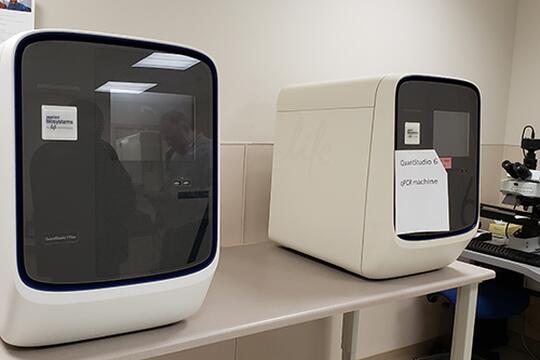 The University of Illinois has loaned a pair of real-time quantitative polymerase chain reaction (qPCR) instruments to Carle Health to help perform COVID-19 testing. The machine has the ability to amplify and identify specific RNA segments within a sample. Image courtesy of the Carl R. Woese Institute for Genomic Biology.