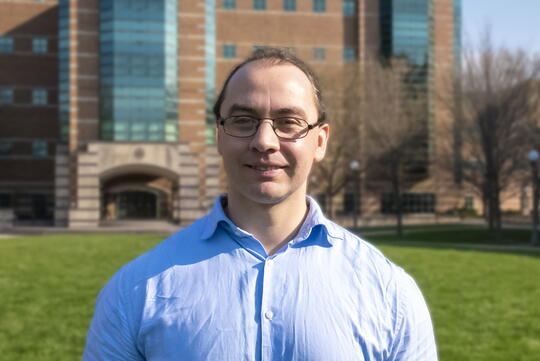 Photo of Alejandro De La Cadena standing outside Beckman Institute smiling for camera.