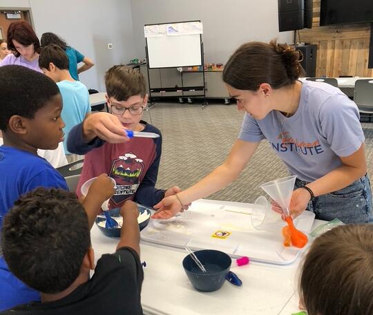 Nicole Godellas facilitates an outreach activity with elementary school students.