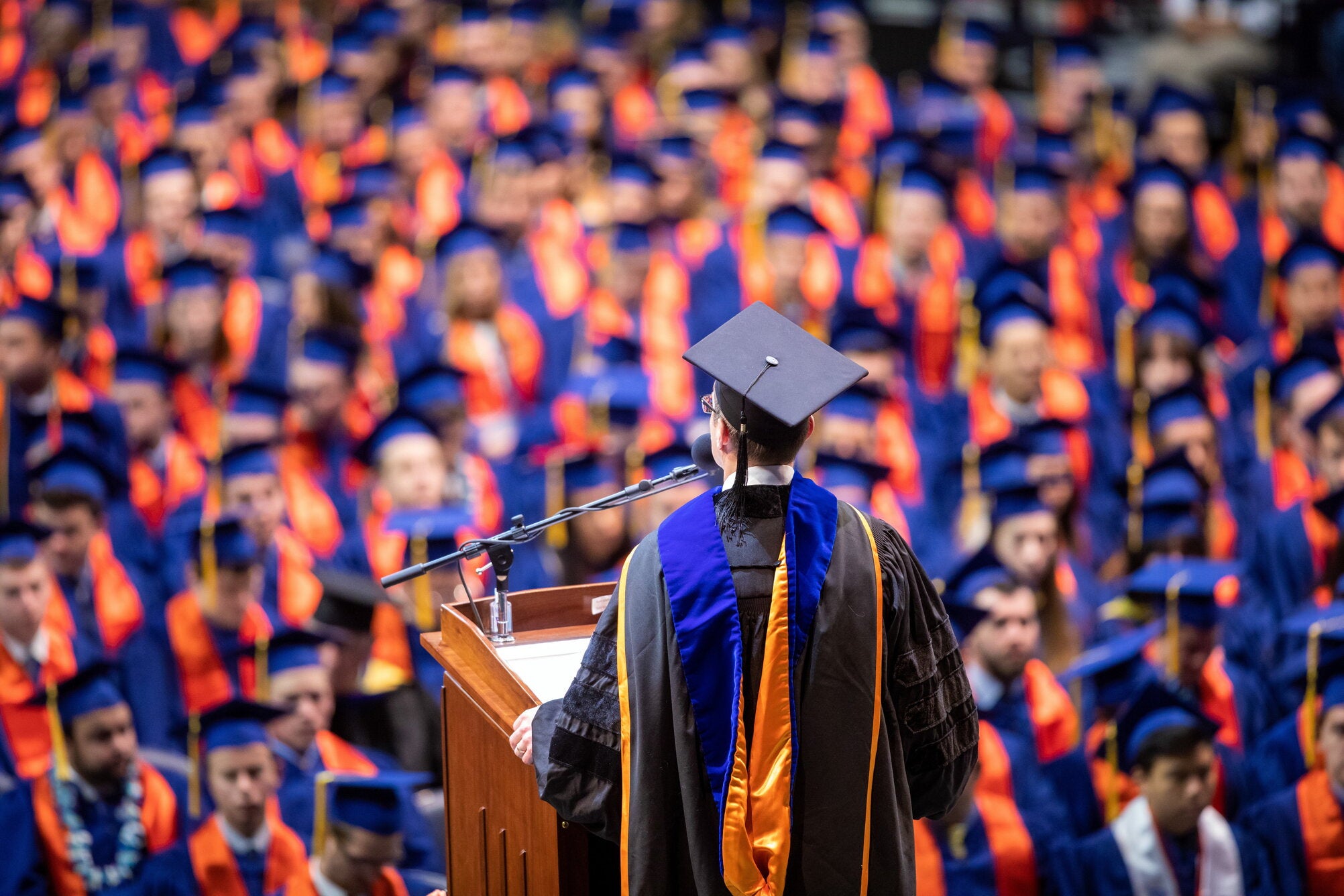 Commencement speaker standing at podium addressing graduates