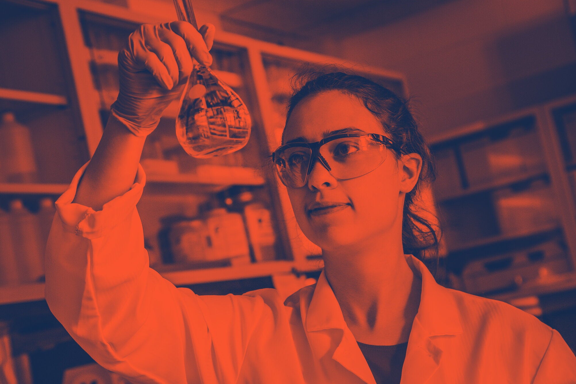 researcher examines test tube