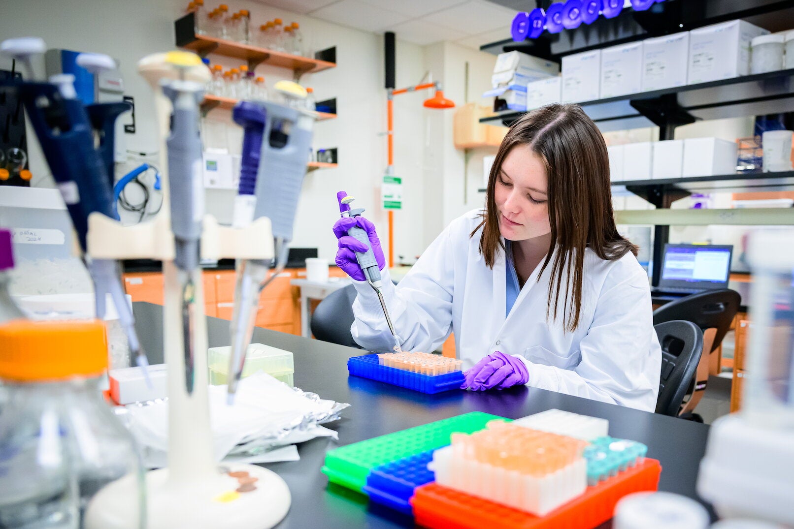 student pipettes in a lab