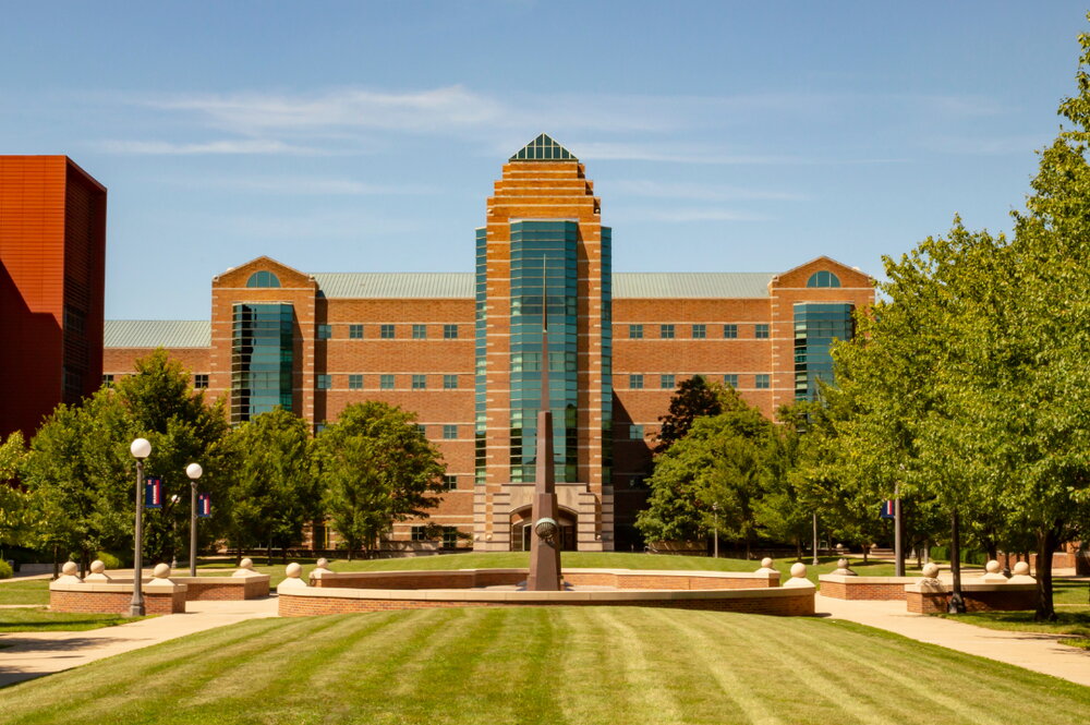 Wide exterior shot of the Beckman Institute on a summer day.