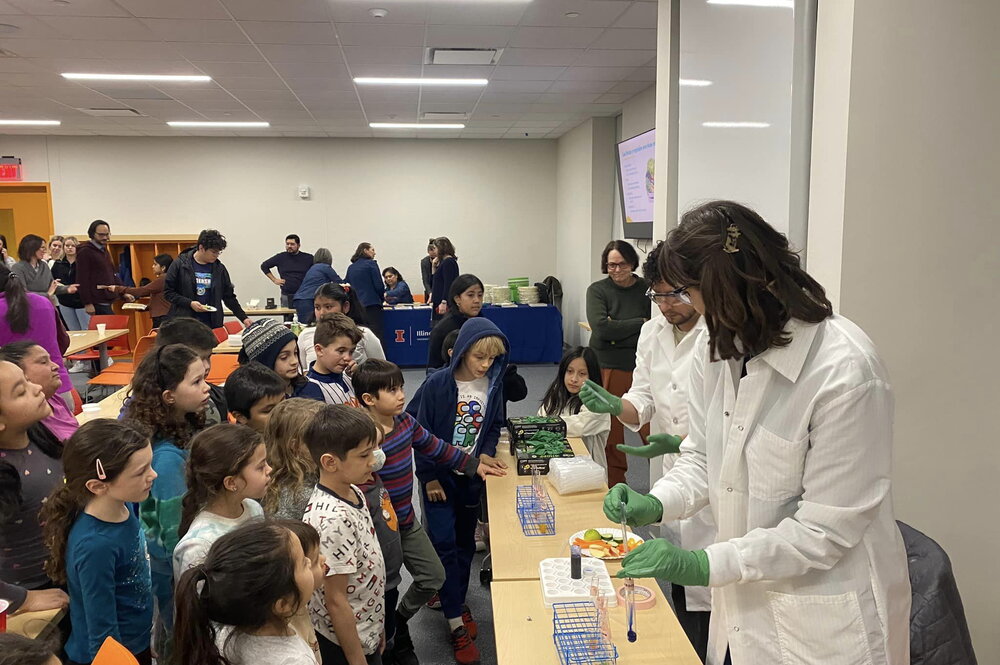 Students gather to watch a microbiology experiment