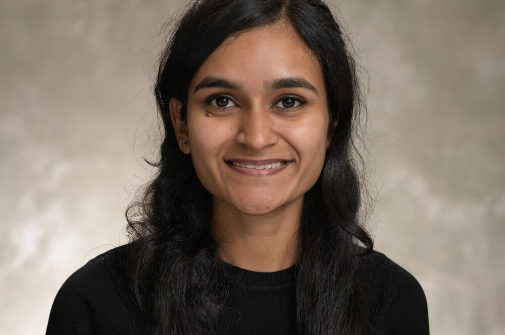 Woman with long black hair wears black shirt