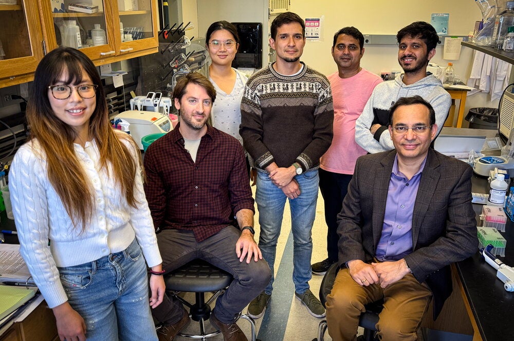 Seven resesarchers gather in Dr. Kevin Van Bortle's cell and developmental biology lab