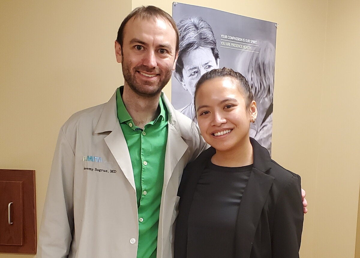 Mentor and mentee pose for photo together.