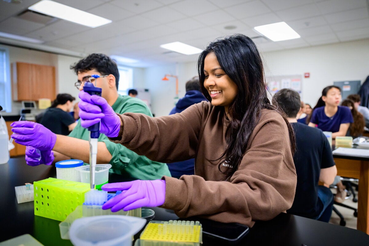A student pipetting.