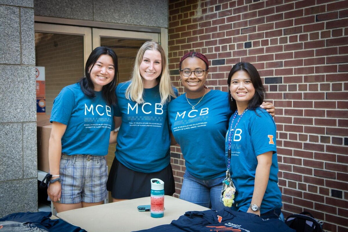 MCB students put arms around each other at a welcome event