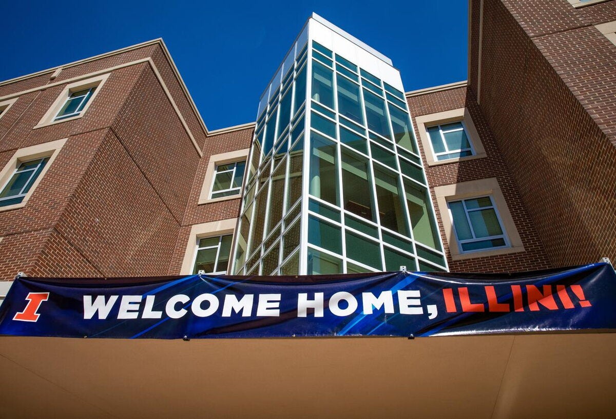 "Welcome Home, Illini" banner waves in front of university housing at UIUC.