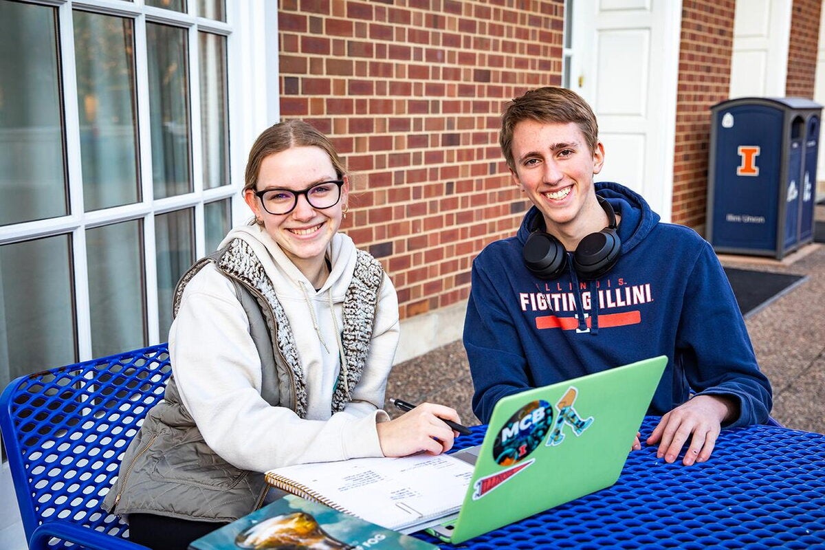 Two students study in front of the Illini Union
