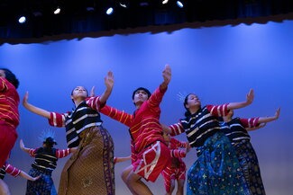 Barkada, the Philippine Association's traditional Filipino dance group, performs on stage. 