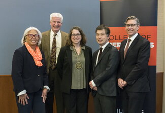 Group photo of faculty members and Whitaker standing together.