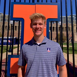 Will Reiser stands outside Memorial Stadium with a large Block I right behind him.