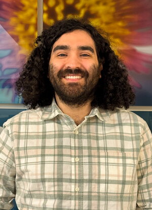 Joe Fernandez, Headshot taken in front of MCB sign