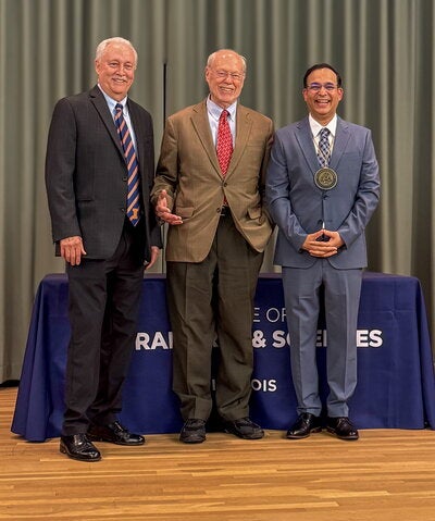 Dave Kranz, Phil Sharp, and Nash Kalostra stand on stage
