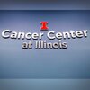 Image of sign on wall that says "Cancer Center at Illinois" with Block I logo above it. 