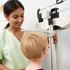 Physician measures child's height at doctor's office.