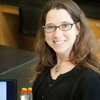 Rachel Whitaker sits at desk, smiling for camera.