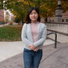 You Jin Song smiles for camera outside on campus on a fall day.