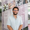 Ruben Sanchez-Nieves stands smiling in the foyer of Carl R. Woese Institute for Genomic Biology.