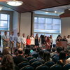 Students stand on stage to accept awards. 