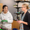 Researchers in conversation in a biochemistry lab