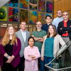 Researchers gather around staircase within the Institute for Genomic Biology