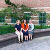 Three women sitting on a bench.