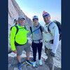 Three men standing on a mountain.