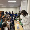 Students gather to watch a microbiology experiment