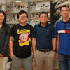 Members of the Lin-Feng Chen lab stand in front of a lab bench