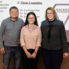 Lin-Feng Chen and Susan Martinis stand in front of projector screen with Phd student Xiaodan Lin