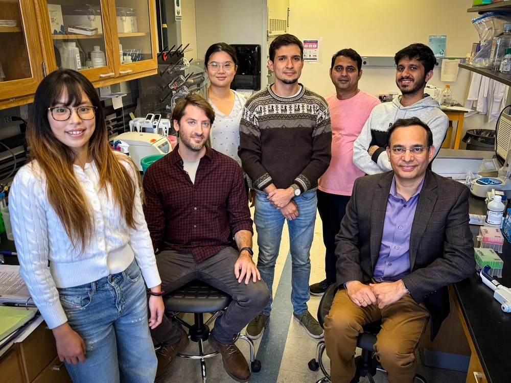 Seven resesarchers gather in Dr. Kevin Van Bortle's cell and developmental biology lab