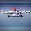 Image of sign on wall that says "Cancer Center at Illinois" with Block I logo above it. 