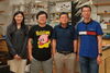 Members of the Lin-Feng Chen lab stand in front of a lab bench