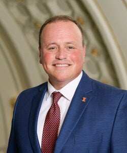 Man in blue suit and marroon tie